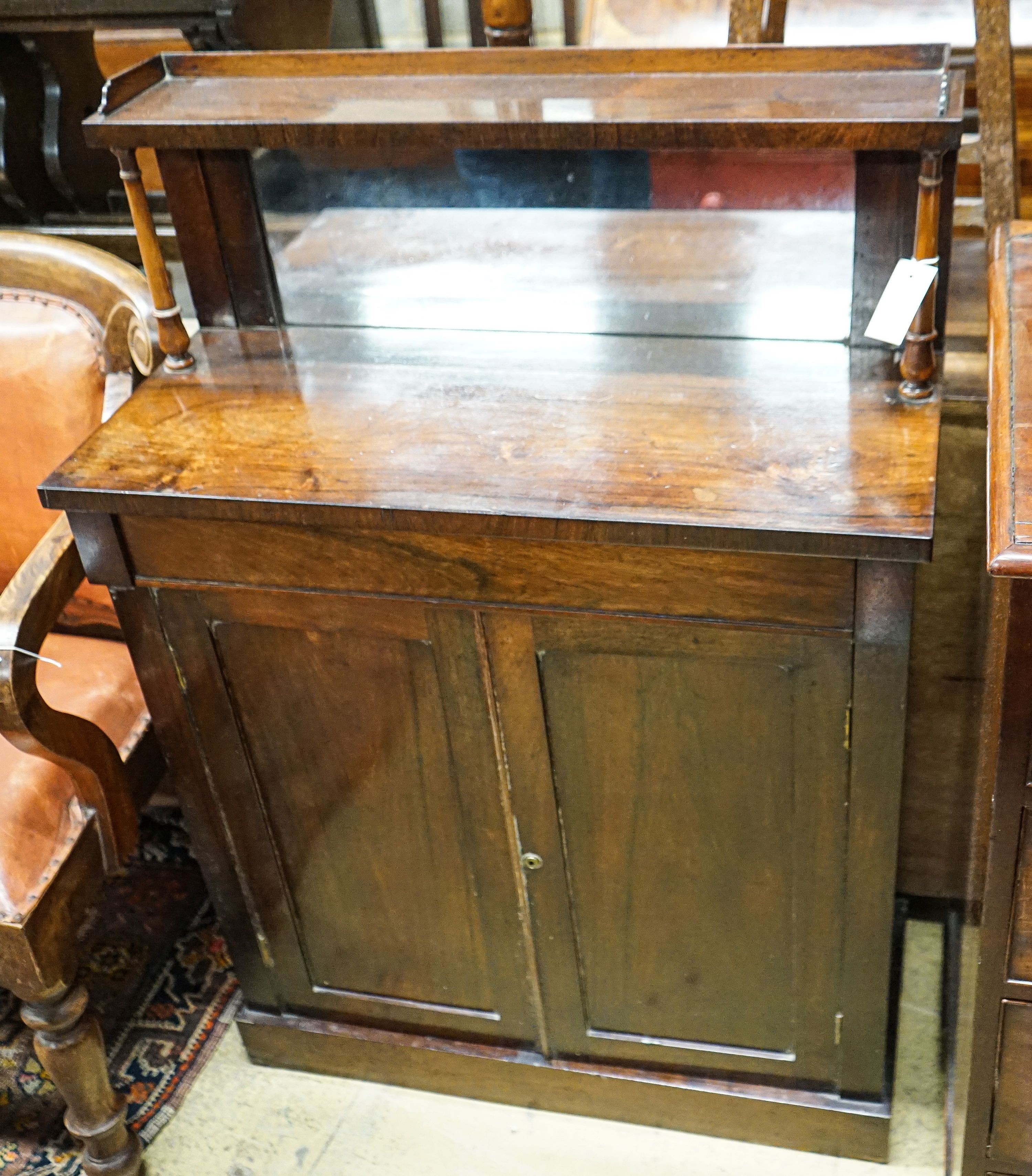 A small Victorian rosewood chiffonier with raised mirror back, 3/4 gallery over a pair of plain panelled doors on plinth base, width 77cm, depth 34cm, height 112cm